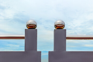 Modern architectural design with polished spheres and minimalist fence