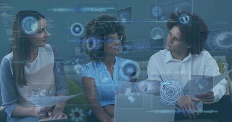 Three colleagues analyzing reports, laptop while data overlays fading in guiding business decision - Powered by Adobe