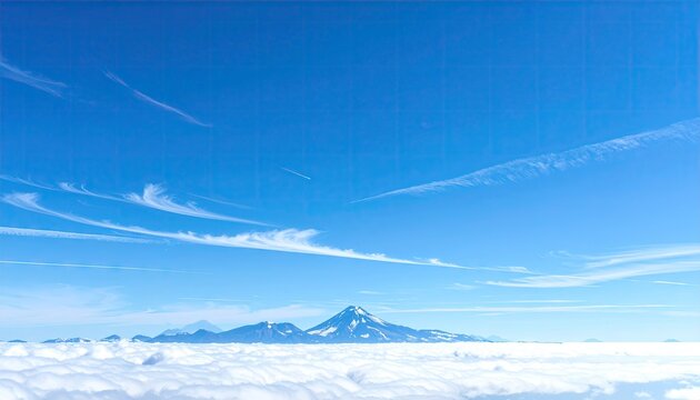 High-altitude view of snow-capped mountain range above clouds