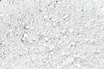 A pile of sparkling pure silver grains, refined to 99.99% perfection, sparkle under the light. Each tiny grain reflects clarity and value.