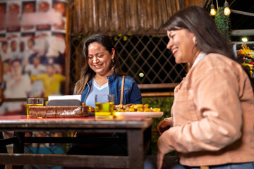 Women enjoying fried food and drinks in restaurant