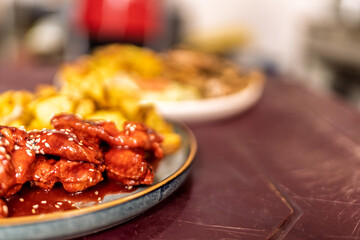 Fried chicken wings with sesame seeds and french fries