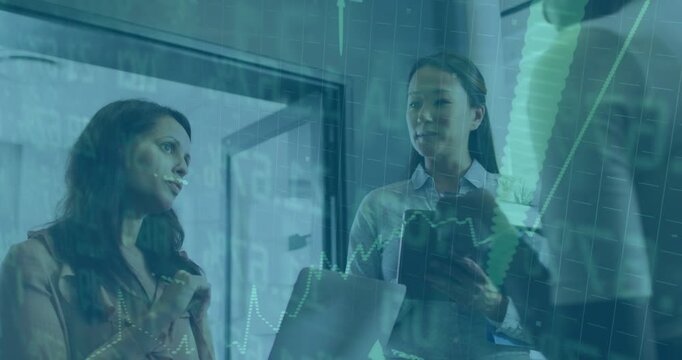 Businesswomen responding to colleague pointing wall charts, scrolling tablet, sharing finance data