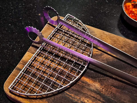arbecue Grill and Tongs on Cutting Board for Korean BBQ