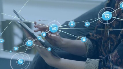 Woman tapping tablet, generating expanding padlock and cart network demonstrating secure e-commerce - Powered by Adobe
