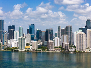 Fototapeta premium Drone view of Brickell skyscrapers. Brickell cityscape of downtown Miami. Panoramic Miami Brickell skyline above the coastline. Brickell Key aerial view in Miami. Landscape of Miami.