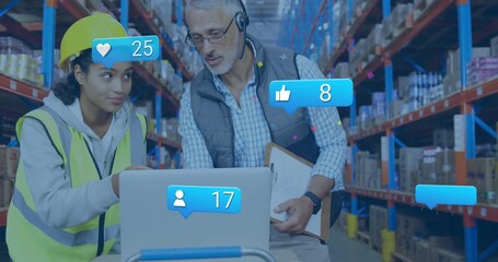 Tapping trackpad warehouse team monitoring laptop overlays updating likes comments and followers - Powered by Adobe