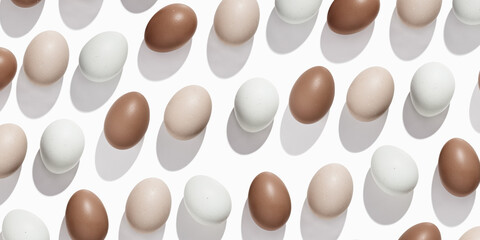 Pattern of Brown and beige Eggs with sun shadows, minimal style aesthetic holiday banner, natural organic chicken eggs, breakfast ingredients,  minimalist food composition, neutral colored