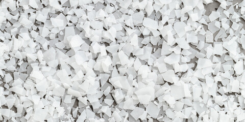 Close-up of magnesium flakes on gray banner background, salt crystalline texture. Natural White sea salt as wellness or spa products for bath or relaxation, self-care or sustainable living