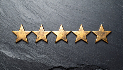 Five Gold Stars on Slate: A top-down perspective captures five meticulously crafted gold stars gracefully arranged upon a textured, dark slate surface, symbolizing the peak of excellence and quality.