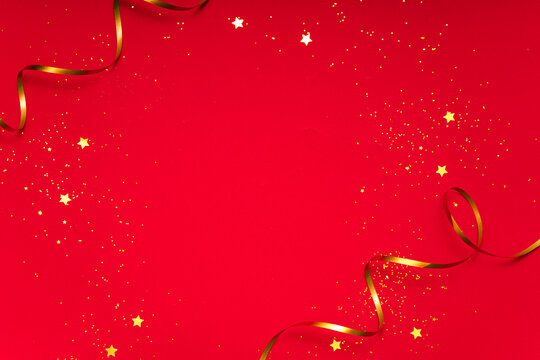 Shiny red christmas background with gold ribbon, glitter confetti and stars. Wide copy space template for poster, banner or social media promo. - Powered by Adobe