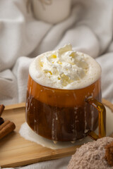 Pumpkin spiced latte morning warming coffee. Fall Drinks for Halloween Thanksgiving Holiday beverage Autumn spicy cinnamon flavor seasonal hot drinking in cozy orange cup. Atmosphere of cold rainy