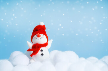 Cheerful winter background with snowman toy and copy space. Suitable for greeting card, banner, poster, social media and holiday promotion.
