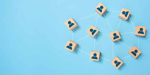 Connecting people partnership or men above social media networks on blue background concept using wooden cube block wood square block on blue background. Digital communication and technology concept.