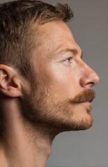 Fototapeta premium Handsome man side profile with mustache and beard looking up