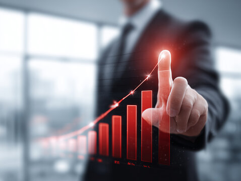 ビジネスマンが指し示すグラフが成長を描く未来志向イメージ