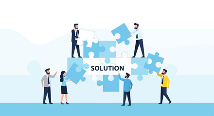 Business team collaboratively assembling a puzzle displaying the word 