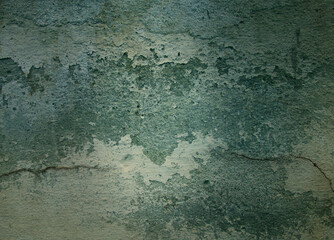 Grunge green cracked concrete wall texture.