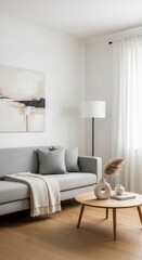 Bright and inviting modern living room with a light grey sofa, abstract art, pampas grass, and white sheer curtains, featuring minimalist and Scandinavian design.