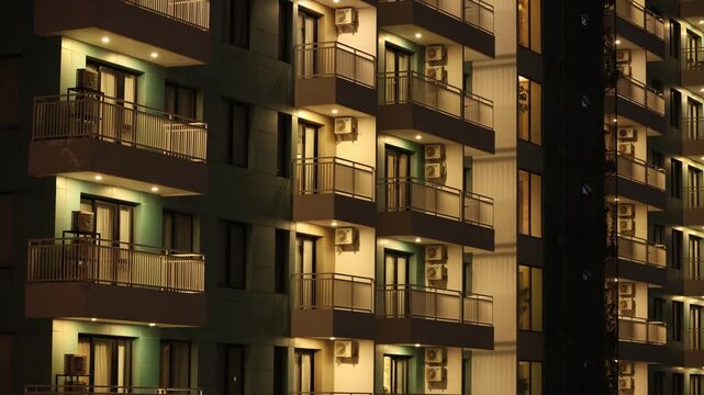 4k Building facade front view at night - architecture exterior. Skyscraper in Big city
