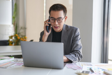 Business asian Man Artist Creative Designer sketch graphic drawing on graphic laptop and Color swatch samples Concept of idea creativity