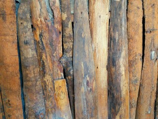Rustic wooden sticks texture with natural bark and rough surface, suitable for organic design and backgrounds.
