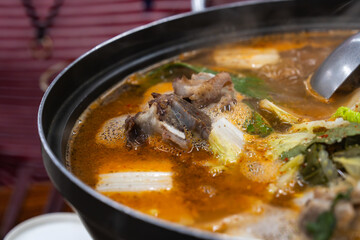 gamjatang. Gamjatang is a hearty Korean pork bone soup. It's made with pork spine simmered in a spicy broth with potatoes, vegetables, and wild sesame seeds.