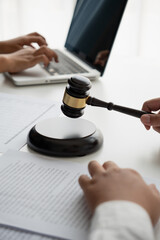 Lawyers meeting with legal counsel, holding lawyer's hammers