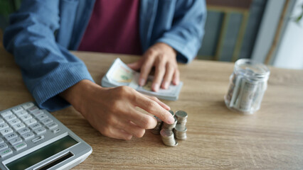 Man planning finances Count banknotes and coinsใ