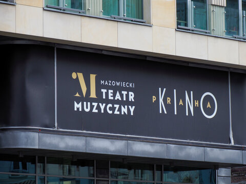 Close-up of a sign for "Muzik Teatr Kino" (Music Theater Cinema) on a modern building facade.