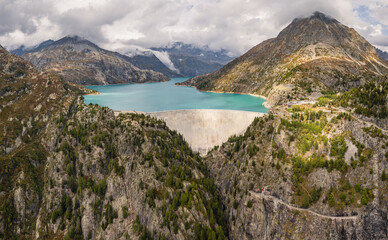 Aerial panoramic view of Emosson Dam and Lake in the Swiss Alps, renewable hydropower reservoir and mountain landscape, sustainable clean energy infrastructure