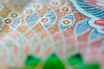 Close-up View of Intricate Colorful Artwork on Currency Note