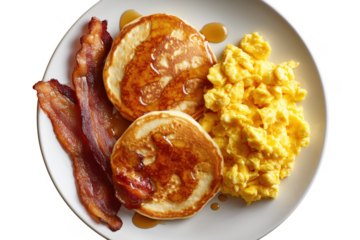 Delicious breakfast plate with pancakes scrambled eggs and crispy bacon served on white plate transparent