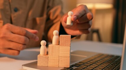 A strategist places a male wooden figure at the top while female figures remain lower, symbolizing workplace inequality, the gender gap in career advancement, challenges in organizational diversity.
