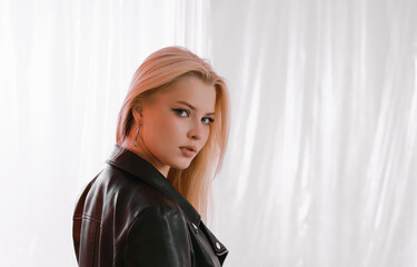 Portrait of a very beautiful blonde woman in a leather jacket.