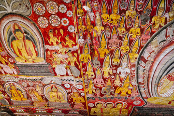Intricate finely crafted murals of Buddha and divine beings from Jataka tales at the Cave of Kings, Dambulla Cave temples built 1st centure BCE by King Valagamba and Lankan kings in Dambulla,Sri Lanka