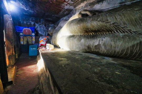 Close up of the 14 m long reclining buddha in parinirvana in the Devaraja lena cave at the Dambulla Cave temples built 1st centure BCE by King Valagamba in Dambulla,Sri Lanka