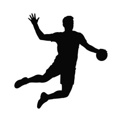 Silhouette of a handball player in mid air throwing the ball