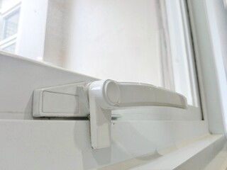 White window handle. White aluminum window lock.