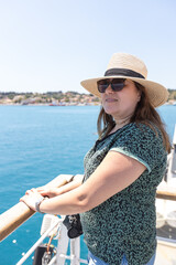 Woman enjoying mediterranean ferry boat journey with scenic ocean views