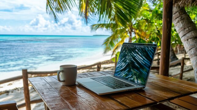 A serene beach scene featuring a laptop and a coffee cup on a wooden table, surrounded by palm trees and a turquoise ocean in the background. - Powered by Adobe