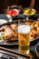 A cold glass of beer with a rich pub meal.