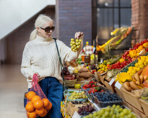 A woman at the market chooses fruits