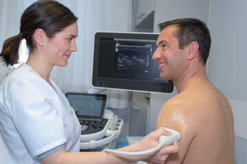 middle-aged man having ultrasound of his upper arm