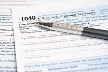 Tax Return form 1040 with pencil, U.S. Individual Income.