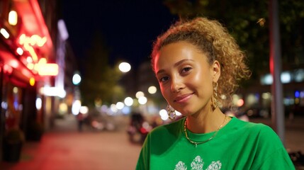 Smiling young adult female with curly hair on nighttime city street