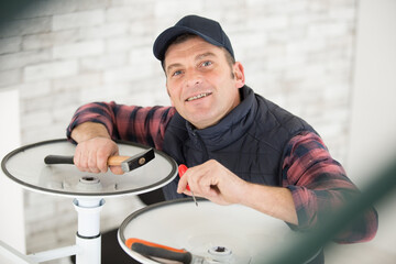 professional repairman repairing computer in workshop