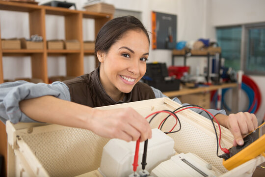 electronics repair tech fixes circuit board