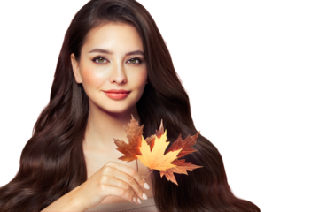 Portrait of beautiful young woman with autumn leafs. Healthy clean fresh skin natural make up.Long curly hairstyle. Care and beauty hair products