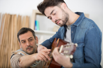 Fototapeta premium man learning to play the guitar